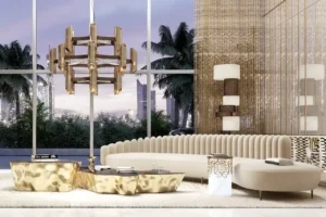 Grand Bleu Tower at Emaar Beachfront by Emaar luxury living lounge with sculptural seating gold finishes and floor to ceiling windows overlooking palm trees in Dubai - Presented by Tohid Fetrat
