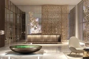 Grand Bleu Tower at Emaar Beachfront by Emaar luxury lobby with decorative metal screens marble flooring and reception desk in Dubai - Presented by Tohid Fetrat