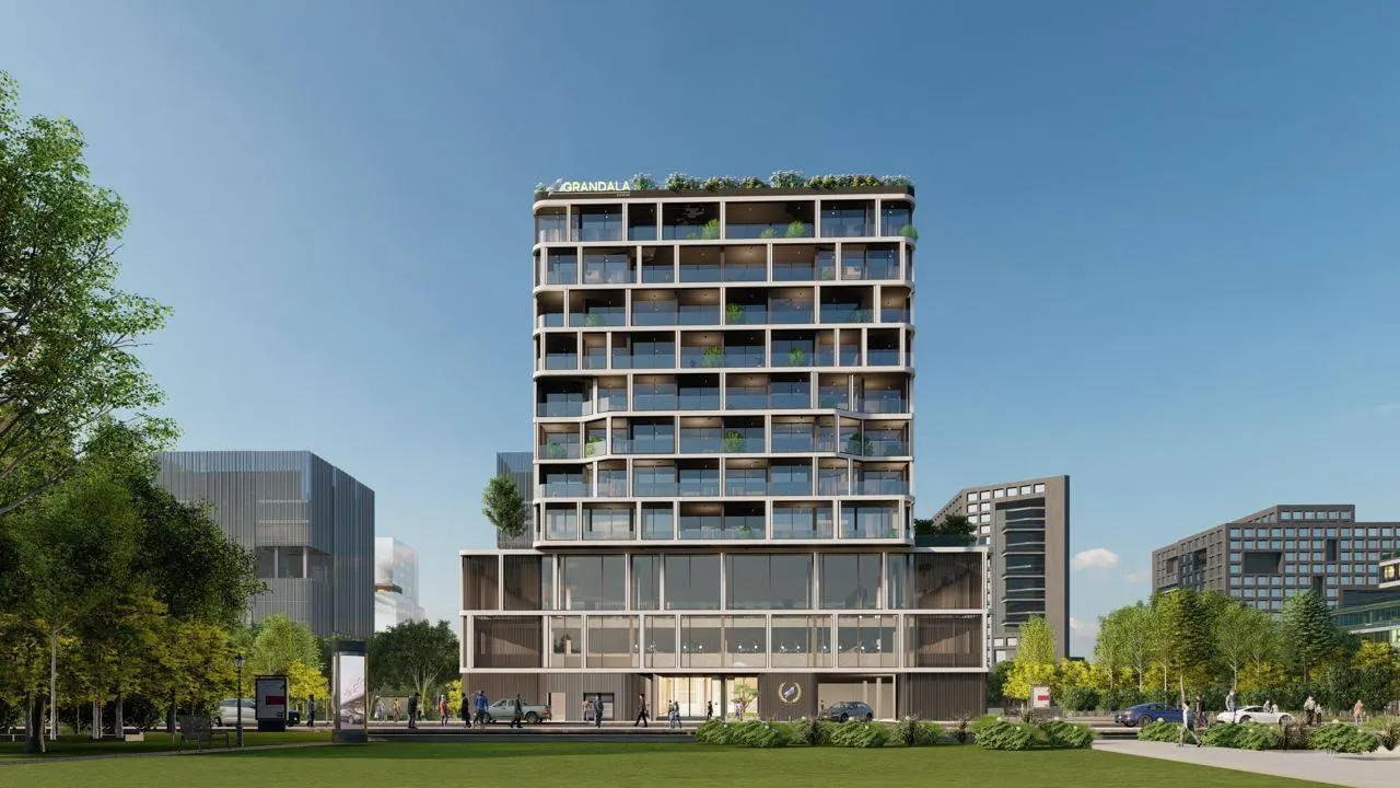 Grandala Construction Update May 2024 showing modern mid rise building exterior with structured facade and landscaped surroundings in Dubai Presented by Tohid Fetrat