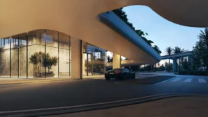 LUMENA by Omniyat office tower drop off entrance with curved canopy glass facade and luxury car arrival in Dubai - Presented by Tohid Fetrat