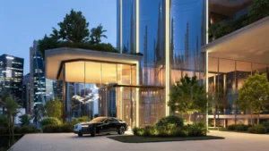 LUMENA by Omniyat office tower entrance with illuminated glass lobby landscaped surroundings and luxury car at drop off area in Dubai - Presented by Tohid Fetrat