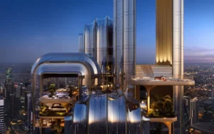 LUMENA by Omniyat office tower rooftop terrace with lounge seating and illuminated architectural facade overlooking Dubai skyline at night - Presented by Tohid Fetrat