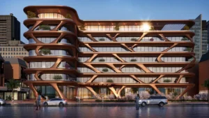 Magnolia Apartments Hotel at Dubai Internet City by Palladium Development illuminated exterior with flowing architectural lines glass facade and landscaped frontage at sunset in Dubai - Presented by Tohid Fetrat