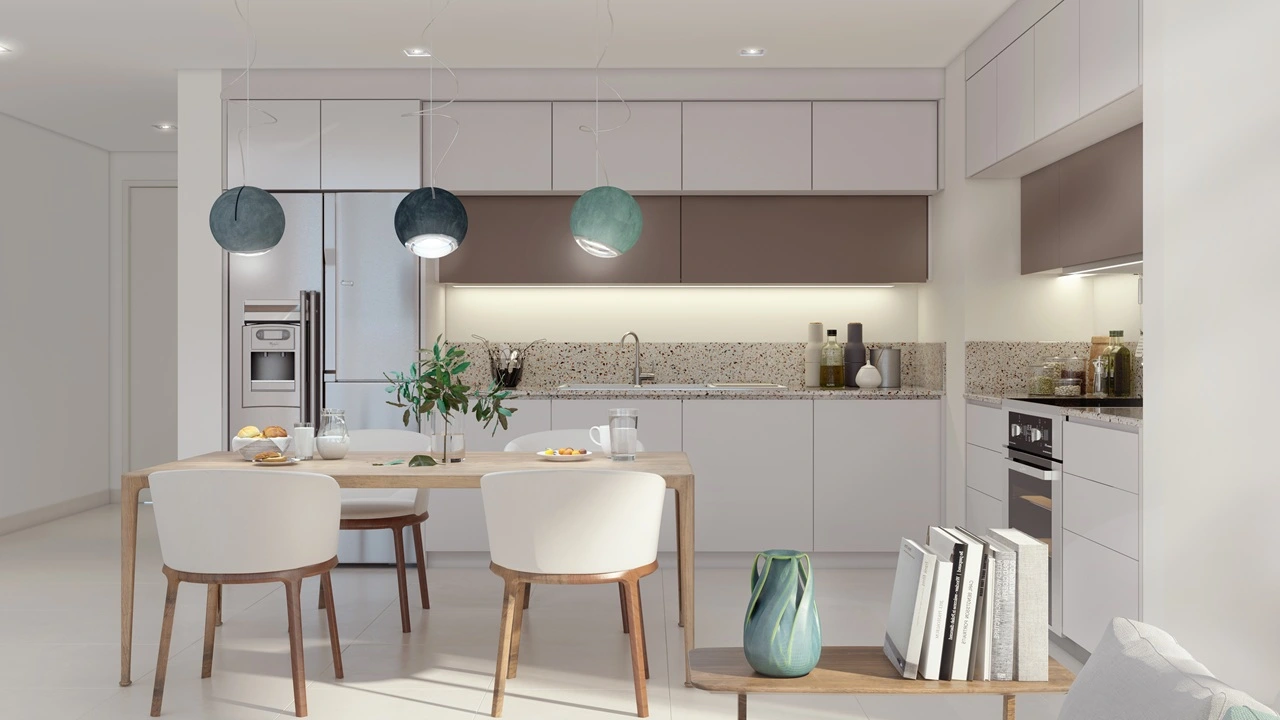 Marina Vista at Emaar Beachfront by Emaar open kitchen and dining area with modern cabinetry and pendant lighting in Dubai - Presented by Tohid Fetrat