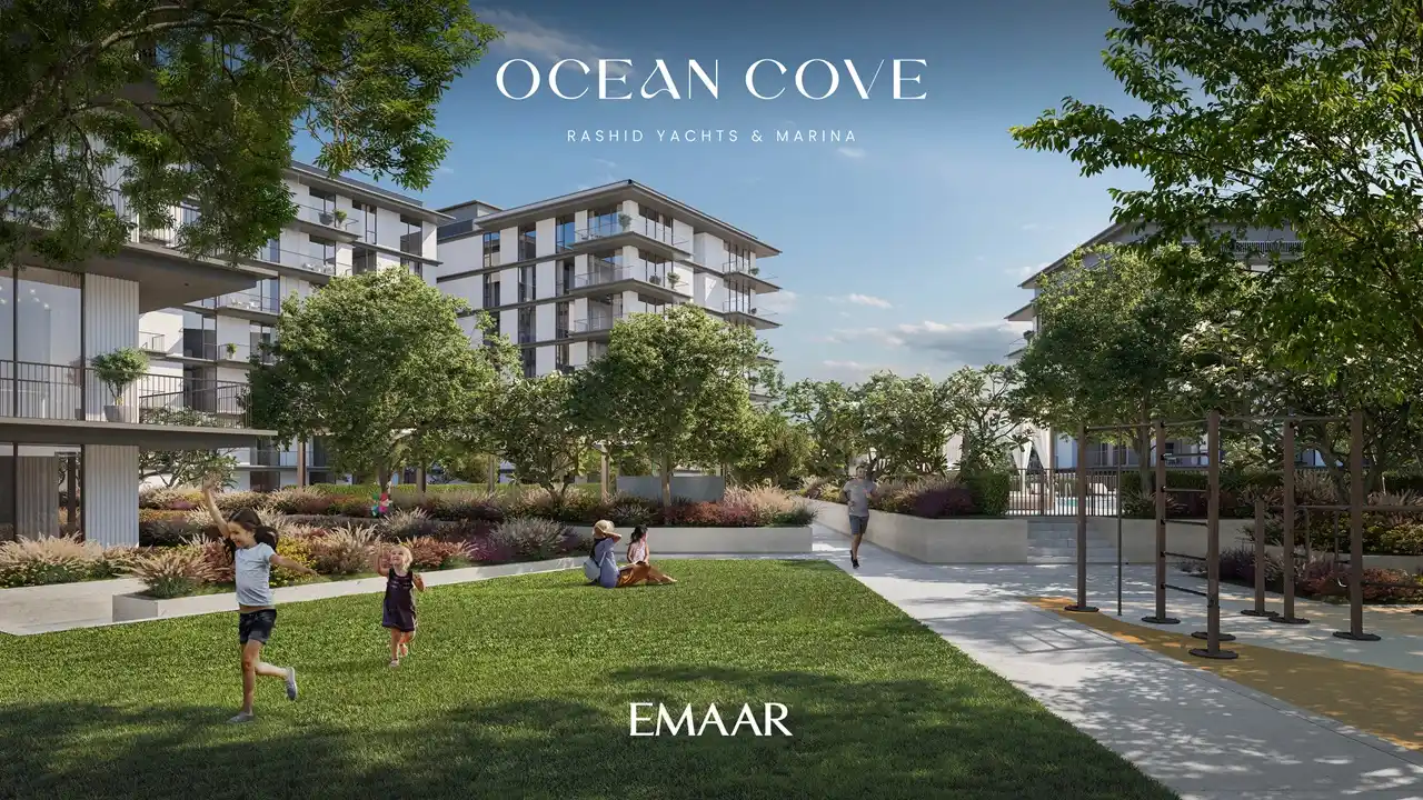 Ocean Cove at Rashid Yachts & Marina by Emaar landscaped garden with walking paths green lawn and residential buildings in Dubai - Presented by Tohid Fetrat