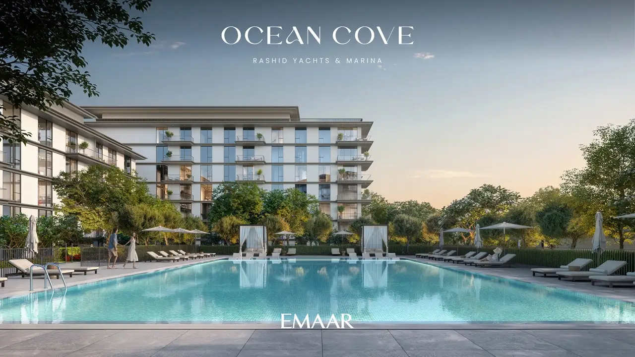Ocean Cove at Rashid Yachts & Marina by Emaar outdoor swimming pool with sun loungers landscaped surroundings and residential buildings at sunset in Dubai - Presented by Tohid Fetrat