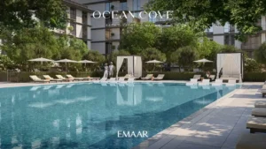 Ocean Cove at Rashid Yachts & Marina by Emaar large outdoor swimming pool with sun loungers cabanas and landscaped surroundings in Dubai - Presented by Tohid Fetrat
