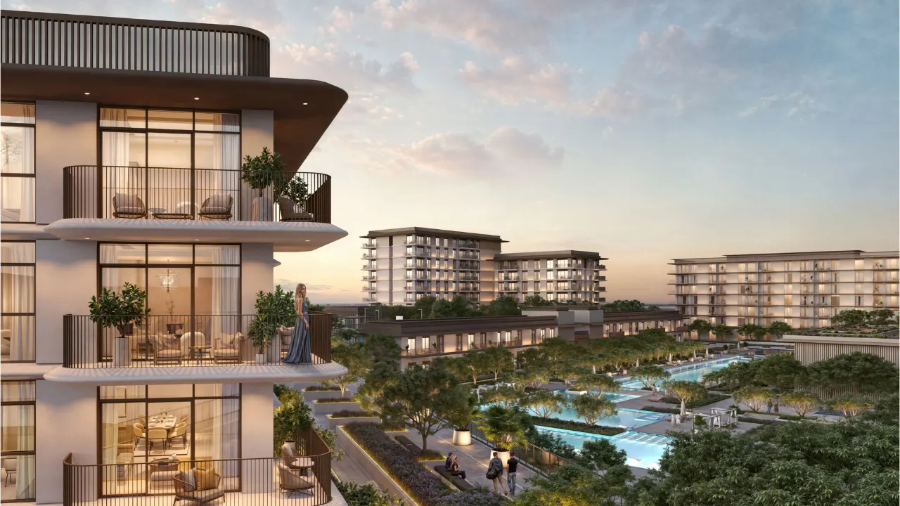 Ocean Star at Rashid Yachts & Marina by Emaar apartment balconies with evening lighting overlooking landscaped pool and waterfront community in Dubai - Presented by Tohid Fetrat