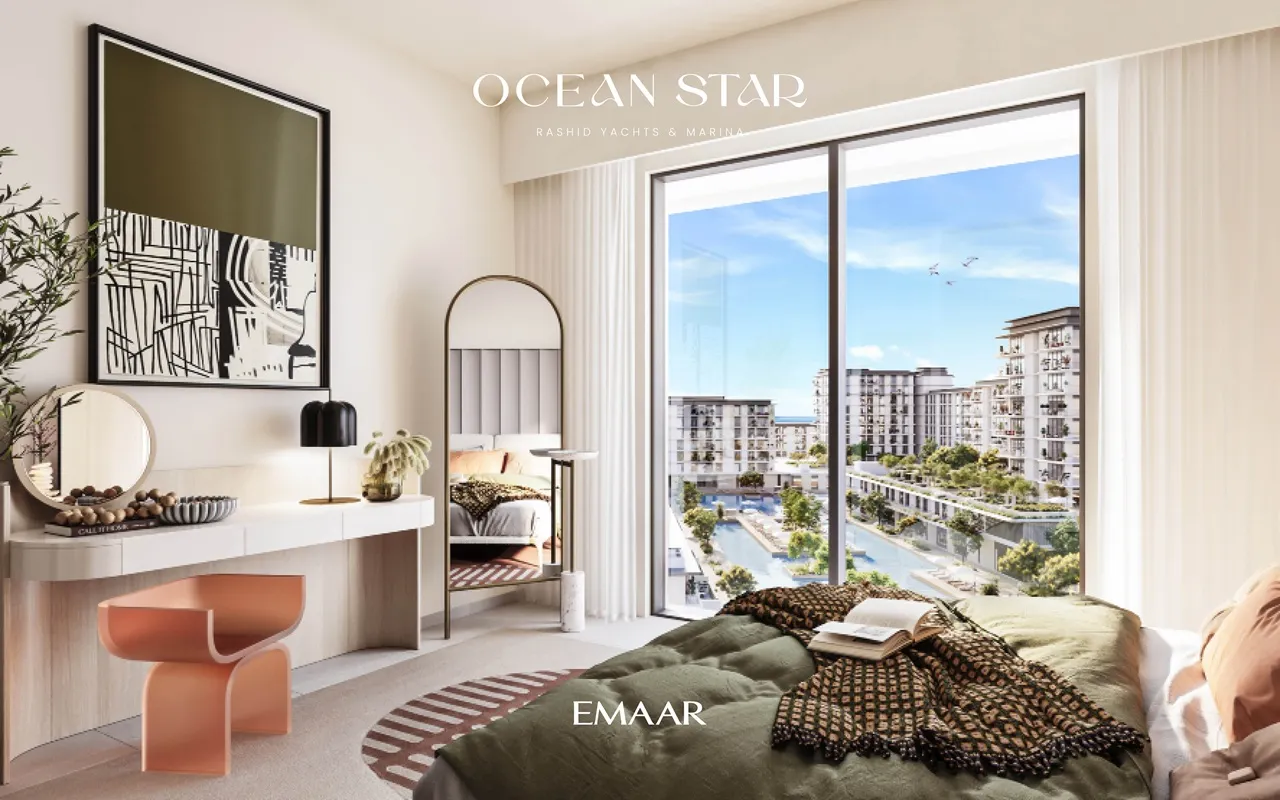 Ocean Star at Rashid Yachts & Marina by Emaar bedroom interior with large window overlooking landscaped pool and residential buildings in Dubai - Presented by Tohid Fetrat