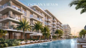 Ocean Views at Rashid Yachts & Marina by Emaar luxury apartments with poolside loungers, palm trees, and modern facade in Dubai - Presented by Tohid Fetrat