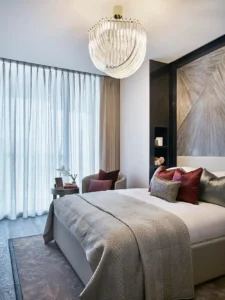 One at Palm Jumeirah Dorchester Collection by Omniyat bedroom with chandelier soft furnishings and modern decor in Dubai - Presented by Tohid Fetrat