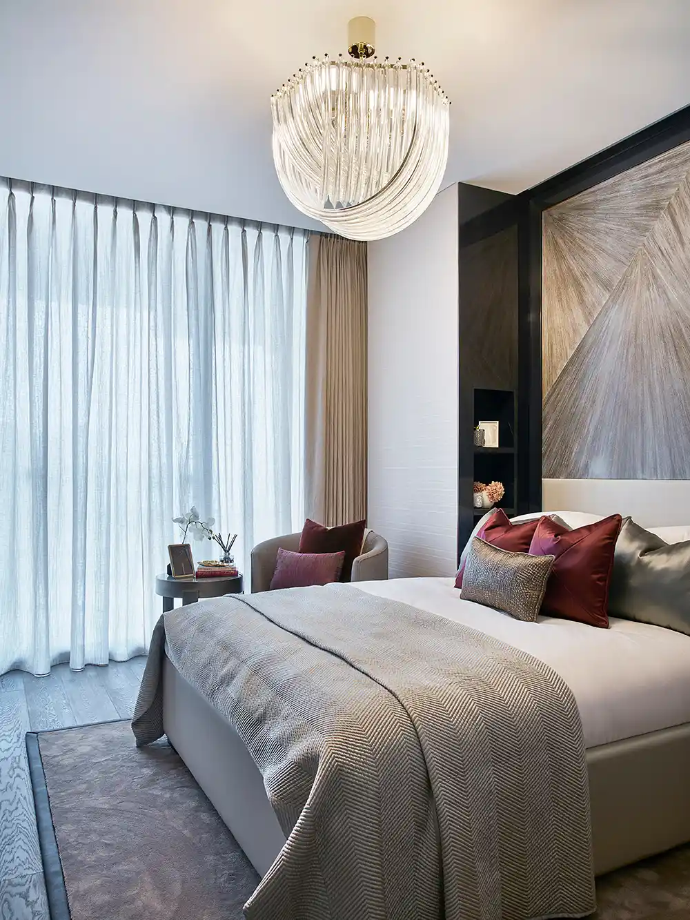 One at Palm Jumeirah Dorchester Collection by Omniyat bedroom with chandelier soft furnishings and modern decor in Dubai - Presented by Tohid Fetrat