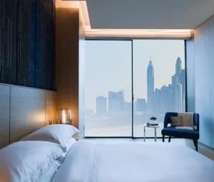 One at Palm Jumeirah Dorchester Collection by Omniyat bedroom with floor to ceiling window and skyline view in Dubai - Presented by Tohid Fetrat