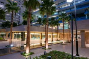 One at Palm Jumeirah Dorchester Collection by Omniyat landscaped courtyard with palm trees water features and modern architecture in Dubai - Presented by Tohid Fetrat
