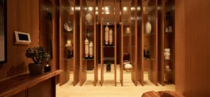 One at Palm Jumeirah Dorchester Collection by Omniyat decorative display lounge with wooden panels and curated art pieces in Dubai - Presented by Tohid Fetrat