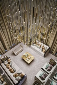 One at Palm Jumeirah Dorchester Collection by Omniyat double height living room top view with statement chandelier and elegant seating in Dubai - Presented by Tohid Fetrat