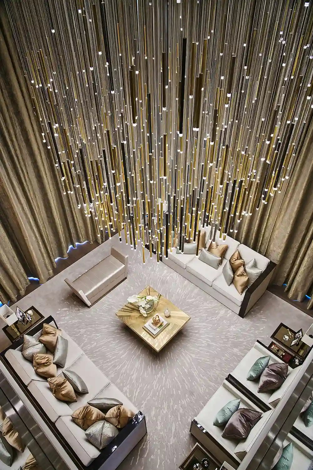 One at Palm Jumeirah Dorchester Collection by Omniyat double height living room top view with statement chandelier and elegant seating in Dubai - Presented by Tohid Fetrat