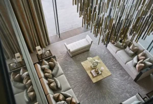 One at Palm Jumeirah Dorchester Collection by Omniyat double height living room with chandelier and lounge seating in Dubai - Presented by Tohid Fetrat