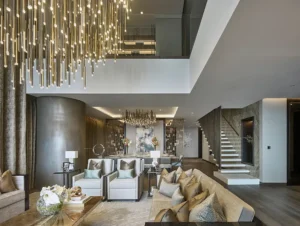 One at Palm Jumeirah Dorchester Collection by Omniyat duplex living and dining area with chandelier and staircase in Dubai - Presented by Tohid Fetrat