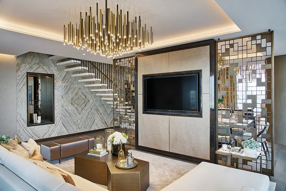 One at Palm Jumeirah Dorchester Collection by Omniyat living area with TV feature wall chandelier and staircase in Dubai - Presented by Tohid Fetrat