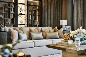 One at Palm Jumeirah Dorchester Collection by Omniyat living room with plush sofa decorative shelving and elegant styling in Dubai - Presented by Tohid Fetrat