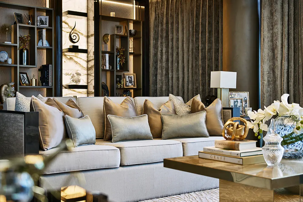 One at Palm Jumeirah Dorchester Collection by Omniyat living room with plush sofa decorative shelving and elegant styling in Dubai - Presented by Tohid Fetrat