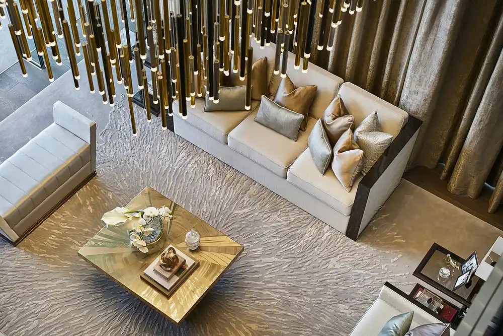 One at Palm Jumeirah Dorchester Collection by Omniyat living room top view with chandelier and elegant seating arrangement in Dubai - Presented by Tohid Fetrat