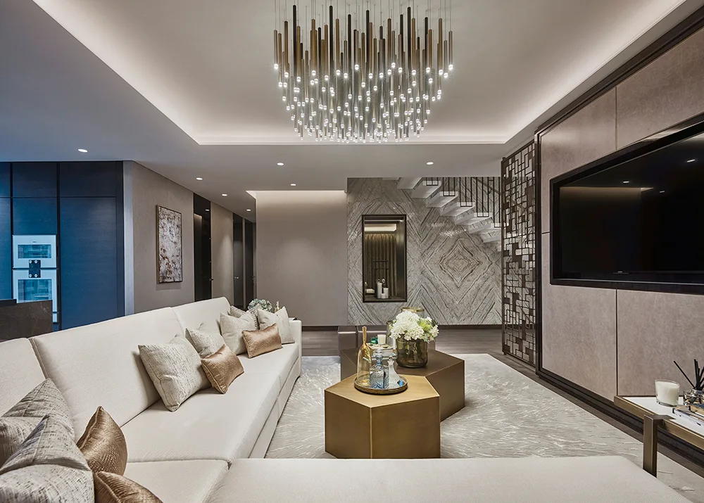 One at Palm Jumeirah Dorchester Collection by Omniyat living room with TV feature wall modern chandelier and elegant seating in Dubai - Presented by Tohid Fetrat