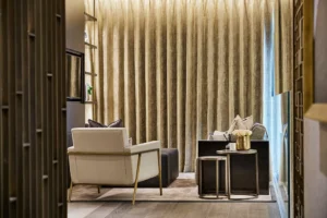 One at Palm Jumeirah Dorchester Collection by Omniyat private lounge seating area with soft furnishings and curtains in Dubai - Presented by Tohid Fetrat