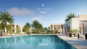 Orania at The Valley by Emaar community pool with modern townhouses palm trees and leisure seating in Dubai - Presented by Tohid Fetrat