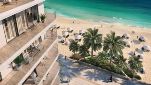 Palace Beach Residence at Emaar Beachfront by Emaar elevated balcony view overlooking sandy beach palm trees and turquoise water in Dubai - Presented by Tohid Fetrat