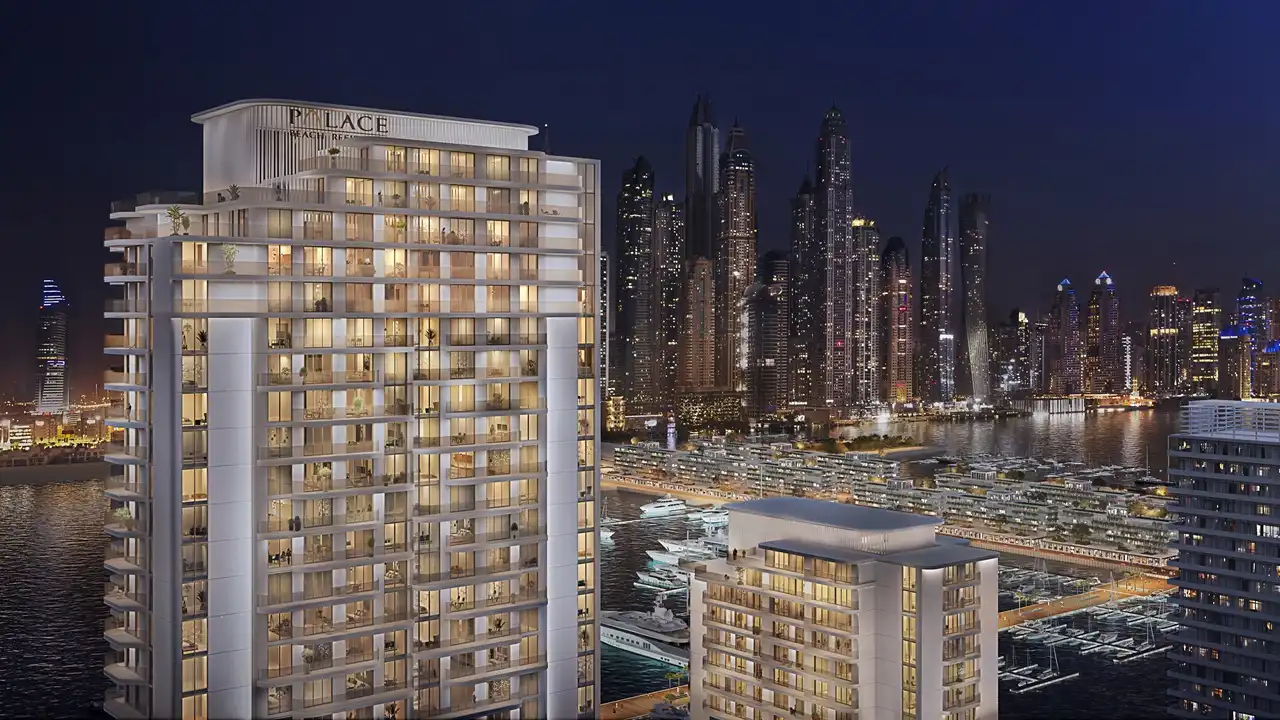 Palace Beach Residence at Emaar Beachfront by Emaar illuminated residential tower with marina skyline and waterfront at night in Dubai - Presented by Tohid Fetrat