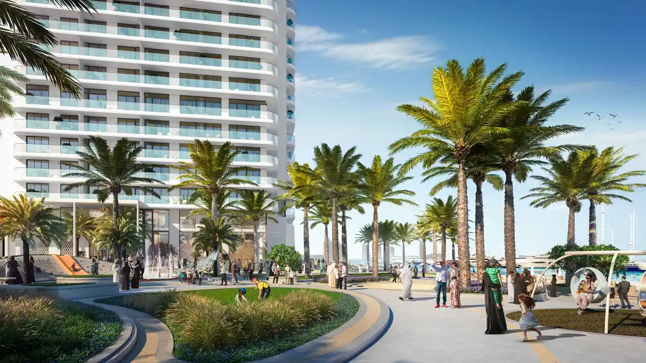 Palace Beach Residence at Emaar Beachfront by Emaar waterfront promenade with palm trees landscaped walkways and residential tower in Dubai - Presented by Tohid Fetrat
