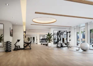 Palace Beach Residence at Emaar Beachfront by Emaar modern gym with strength training equipment cardio machines and large windows in Dubai - Presented by Tohid Fetrat