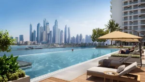 Palace Beach Residence at Emaar Beachfront by Emaar infinity pool with marina skyline view sun loungers and waterfront setting in Dubai - Presented by Tohid Fetrat