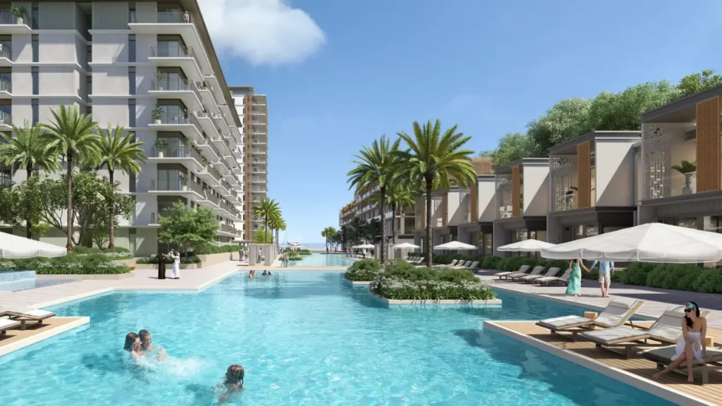 Seascape at Rashid Yachts & Marina by Emaar lagoon style pool with sun loungers palm trees and waterfront residences in Dubai - Presented by Tohid Fetrat
