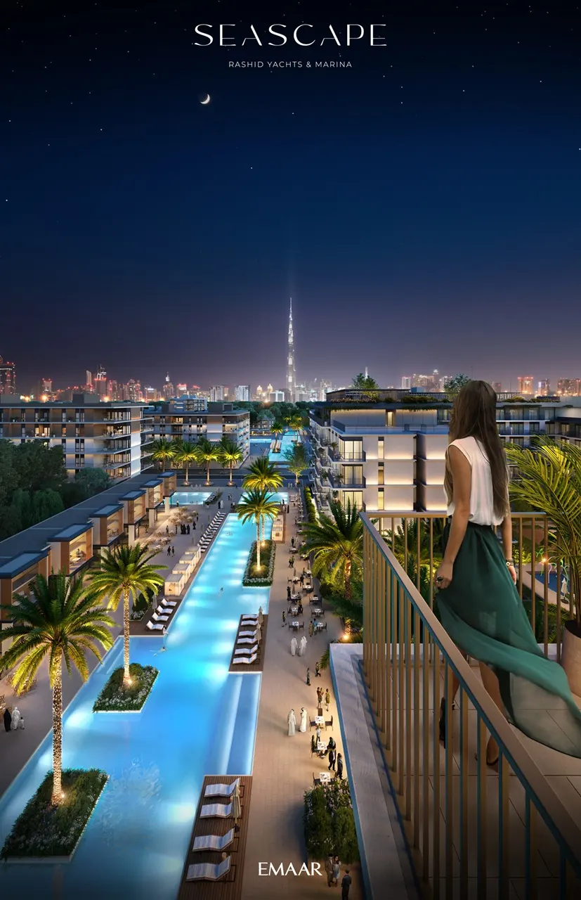 Seascape at Rashid Yachts & Marina by Emaar night view of illuminated pool promenade palm trees and city skyline in Dubai - Presented by Tohid Fetrat