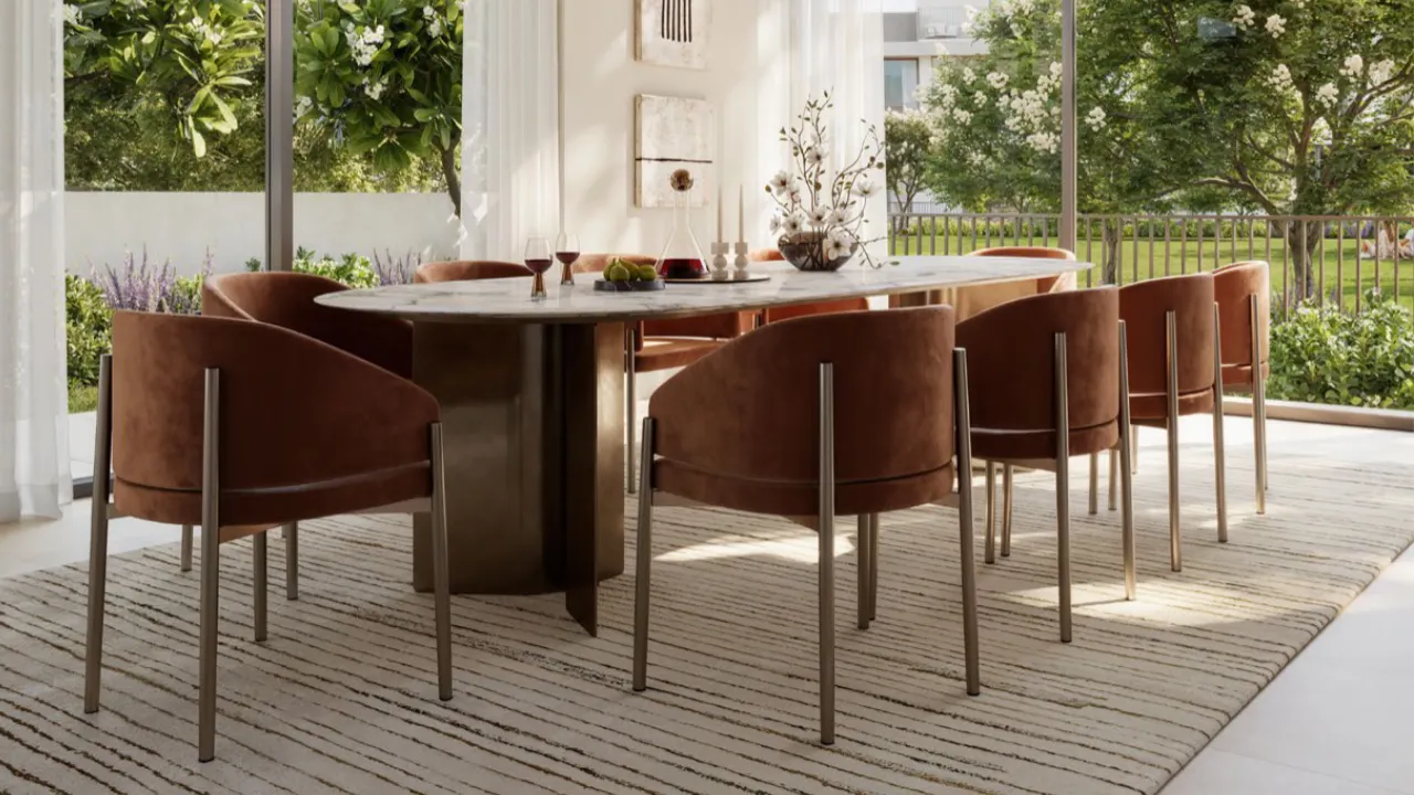Selvara at Grand Polo Club & Resort by Emaar elegant dining area interior with marble table, upholstered chairs, floor to ceiling windows, and garden views in Dubai Presented by Tohid Fetrat