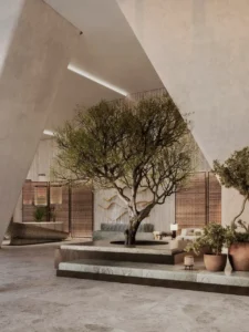 Six Senses Residences Dubai Marina by Select Group lobby with indoor tree natural stone finishes and serene seating areas in Dubai - Presented by Tohid Fetrat