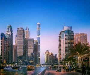 Six Senses Residences Dubai Marina by Select Group view of Dubai Marina Walk at evening with skyline waterfront promenade and boats in Dubai - Presented by Tohid Fetrat