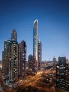 Six Senses Residences Dubai Marina by Select Group tower at night with illuminated facade and surrounding city skyline in Dubai - Presented by Tohid Fetrat