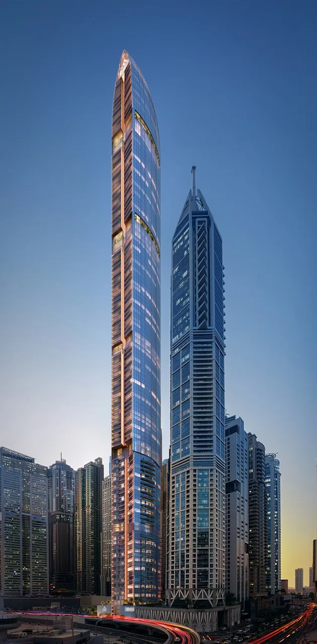 Six Senses Residences Dubai Marina by Select Group tower street level view with illuminated facade and surrounding skyline in Dubai - Presented by Tohid Fetrat