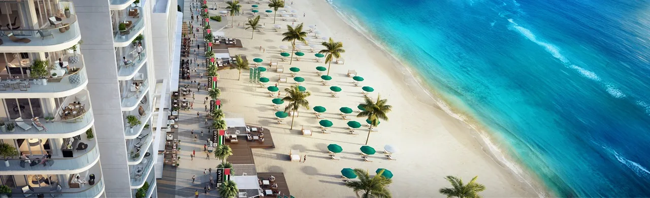 South Beach at Emaar Beachfront by Emaar beachfront promenade with loungers umbrellas and turquoise shoreline in Dubai - Presented by Tohid Fetrat