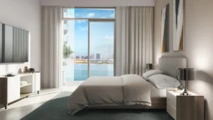 South Beach at Emaar Beachfront by Emaar bedroom interior with large window overlooking sea view in Dubai - Presented by Tohid Fetrat
