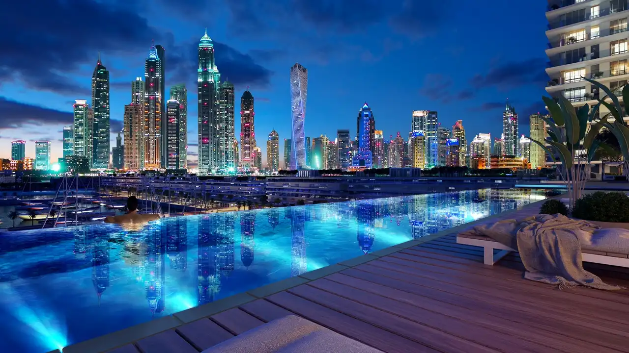Sunrise Bay at Emaar Beachfront by Emaar infinity pool with illuminated marina skyline view at night and luxury outdoor lounge in Dubai - Presented by Tohid Fetrat