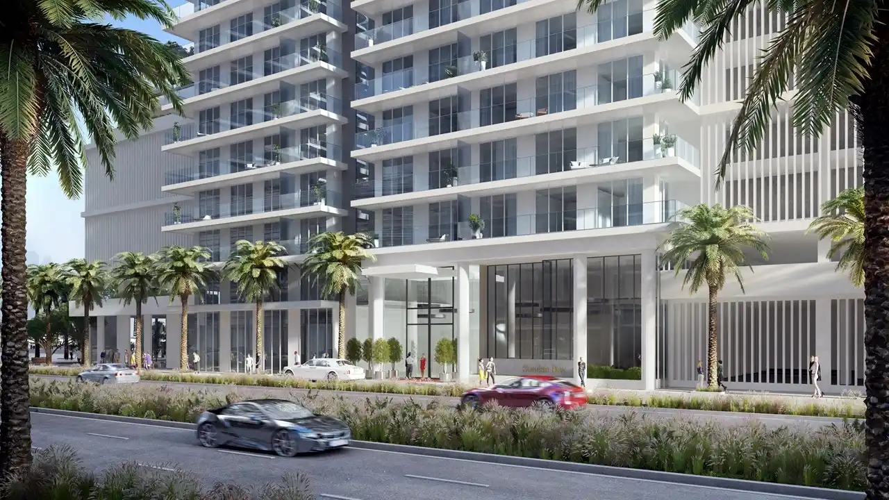 Sunrise Bay at Emaar Beachfront by Emaar podium level entrance with glass facade palm lined street and modern residential exterior in Dubai - Presented by Tohid Fetrat
