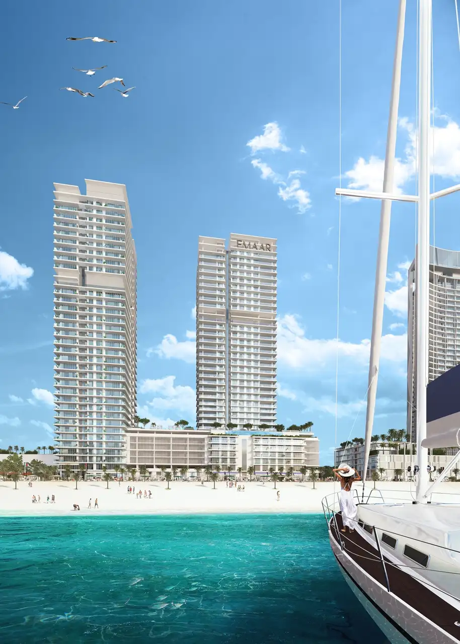 Sunrise Bay at Emaar Beachfront by Emaar twin residential towers viewed from the sea with yacht foreground sandy beach and Gulf waters in Dubai - Presented by Tohid Fetrat