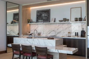 The Lana Residences Dorchester Collection by Omniyat 2 bedroom kitchen interior with marble island and modern cabinetry in Dubai - Presented by Tohid Fetrat