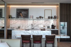 The Lana Residences Dorchester Collection by Omniyat 2 bedroom kitchen with marble island integrated seating and modern appliances in Dubai - Presented by Tohid Fetrat