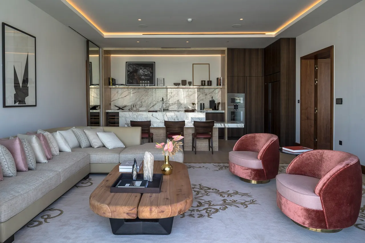 The Lana Residences Dorchester Collection by Omniyat 2 bedroom open plan living area and kitchen with marble island and modern furnishings in Dubai - Presented by Tohid Fetrat